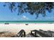 Beautiful beach view, featuring stairs leading to the soft, white sand and turquoise water at 609 Foxworth Ln, Holmes Beach, FL 34217