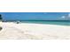 Panoramic beach view featuring crystal clear water and a pristine shoreline, perfect for a relaxing day at 609 Foxworth Ln, Holmes Beach, FL 34217