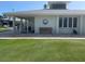Exterior view of the Key Royale Golf Club building with a bench and well-maintained lawn at 609 Foxworth Ln, Holmes Beach, FL 34217