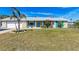 Charming single-story home featuring a lush front lawn and coastal accents at 609 Foxworth Ln, Holmes Beach, FL 34217
