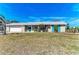 Attractive single-story home featuring turquoise shutters and a large front yard at 609 Foxworth Ln, Holmes Beach, FL 34217