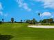 Picturesque golf course featuring rolling green hills and a serene pond at 609 Foxworth Ln, Holmes Beach, FL 34217