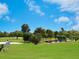 Scenic golf course view with a sand trap and a golfer at 609 Foxworth Ln, Holmes Beach, FL 34217