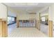 Open concept kitchen with white tile flooring, awaiting renovation with great natural light at 609 Foxworth Ln, Holmes Beach, FL 34217