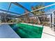 Screened-in pool and deck area surrounded by lush landscaping and trees at 609 Foxworth Ln, Holmes Beach, FL 34217