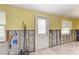 An unfinished yellow room reveals exposed walls and the potential for custom design at 609 Foxworth Ln, Holmes Beach, FL 34217