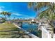 Waterfront view of a canal with palm trees and homes in the background at 609 Foxworth Ln, Holmes Beach, FL 34217