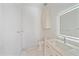 A pristine white bathroom is complete with marble floors, modern vanity, and illuminated mirror at 656 Tropical Cir, Sarasota, FL 34242