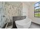 Luxurious bathroom with a soaking tub, walk-in shower, and elegant marble accents exudes spa-like serenity at 656 Tropical Cir, Sarasota, FL 34242