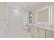Clean, all-white bathroom with shower-tub, framed mirror, and vanity with sink at 656 Tropical Cir, Sarasota, FL 34242