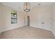 Spacious bedroom with high ceilings, modern lighting, and ample closet space offers comfortable living at 656 Tropical Cir, Sarasota, FL 34242