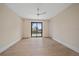 Spacious bedroom features hardwood floors, ceiling fan, and sliding glass doors at 656 Tropical Cir, Sarasota, FL 34242