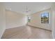 Spacious bedroom features a ceiling fan, two large windows, and light wood flooring at 656 Tropical Cir, Sarasota, FL 34242