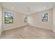 Bright bedroom featuring hardwood floors, a ceiling fan, and three windows offering natural light at 656 Tropical Cir, Sarasota, FL 34242