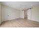 Bedroom featuring hardwood floors, ceiling fan, and barn doors to another room at 656 Tropical Cir, Sarasota, FL 34242