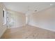 Large bedroom with wood floors, ceiling fan, and ensuite bathroom at 656 Tropical Cir, Sarasota, FL 34242