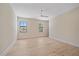 Spacious bedroom features a ceiling fan, two large windows, and light wood flooring at 656 Tropical Cir, Sarasota, FL 34242