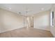 Bright bedroom featuring hardwood floors, a ceiling fan, and views into the hallway at 656 Tropical Cir, Sarasota, FL 34242