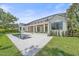 A modern exterior features a pool and manicured lawn, with an open porch and elegant design at 656 Tropical Cir, Sarasota, FL 34242