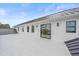 Exterior view of deck with modern design, white stucco, and dark metal roof at 656 Tropical Cir, Sarasota, FL 34242