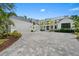 Stunning two-story home features a spacious driveway, clean white exterior, and sophisticated black trim at 656 Tropical Cir, Sarasota, FL 34242