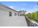 Long view of the exterior deck with metal railings and view of surrounding greenery at 656 Tropical Cir, Sarasota, FL 34242