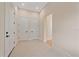 Spacious foyer featuring neutral paint, patterned tile flooring, and access to multiple rooms through white doors at 656 Tropical Cir, Sarasota, FL 34242