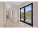 Hallway with wood floors leading to an outdoor patio with black railing at 656 Tropical Cir, Sarasota, FL 34242
