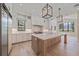Bright kitchen with a large island, custom cabinetry, and state-of-the-art appliances at 656 Tropical Cir, Sarasota, FL 34242