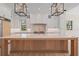 Luxury kitchen featuring marble countertops, custom cabinetry, and a stylish island with seating at 656 Tropical Cir, Sarasota, FL 34242
