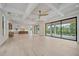 Bright, open-concept living space showcasing beautiful hardwood floors, coffered ceilings, and expansive windows at 656 Tropical Cir, Sarasota, FL 34242