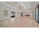 Open-concept living area with ample natural light, hardwood floors, and a seamless flow to the kitchen at 656 Tropical Cir, Sarasota, FL 34242