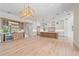 Spacious living space featuring an open-concept kitchen, custom wet bar, and hardwood flooring at 656 Tropical Cir, Sarasota, FL 34242