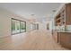 Expansive living space boasts hardwood flooring, natural light, a wet bar, and access to the lanai at 656 Tropical Cir, Sarasota, FL 34242