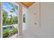 A luxurious outdoor shower features modern fixtures and privacy, with views of the pool and landscaping at 656 Tropical Cir, Sarasota, FL 34242