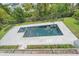 Overhead shot of pool and jacuzzi with stone surround and greenery around perimeter at 656 Tropical Cir, Sarasota, FL 34242