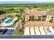 Stunning aerial view of the home with a terracotta roof, pool, golf course, and lush green landscape at 7149 River Hammock Dr # 101, Bradenton, FL 34212