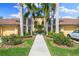 Beautiful home exterior with palm trees, lush landscaping, and a well-maintained walkway leading to the entrance at 7149 River Hammock Dr # 101, Bradenton, FL 34212
