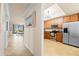 Bright open floor plan showcasing a hallway, dining area, kitchen, and a view to the outside at 7149 River Hammock Dr # 101, Bradenton, FL 34212