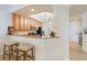 View of a well-equipped kitchen with granite countertops and stainless-steel appliances, open to the dining area at 7149 River Hammock Dr # 101, Bradenton, FL 34212