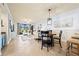 Inviting living room and dining area featuring tile floors, comfortable seating, and serene outdoor views at 7149 River Hammock Dr # 101, Bradenton, FL 34212