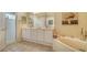 Bathroom featuring double sinks, bathtub and a separate glass door shower at 92 Tall Trees Ct, Sarasota, FL 34232