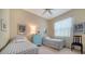 Cozy bedroom featuring two twin beds, a blue dresser, and natural light from a window at 92 Tall Trees Ct, Sarasota, FL 34232