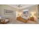 Spacious bedroom with a ceiling fan, natural light, and neutral decor at 92 Tall Trees Ct, Sarasota, FL 34232