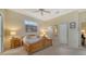 Cozy bedroom featuring a ceiling fan, carpeted floors, and two closets at 92 Tall Trees Ct, Sarasota, FL 34232