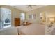 Bright bedroom featuring a ceiling fan, closet and access to the patio at 92 Tall Trees Ct, Sarasota, FL 34232