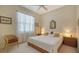 Charming bedroom with a ceiling fan, cozy lighting, and large window at 92 Tall Trees Ct, Sarasota, FL 34232
