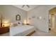 Comfortable bedroom featuring a ceiling fan, carpeted floors, and neutral decor at 92 Tall Trees Ct, Sarasota, FL 34232