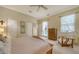 Bright bedroom featuring a ceiling fan, closet and an accent chair at 92 Tall Trees Ct, Sarasota, FL 34232