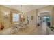 Elegant dining room with a chandelier, ample natural light, and stylish decor at 92 Tall Trees Ct, Sarasota, FL 34232